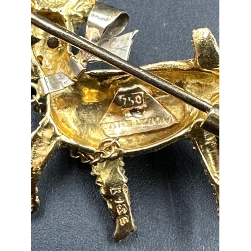 617 - An 18ct gold brooch of a small terrier with pearl capped stick in its mouth (Total weight 5.8g)