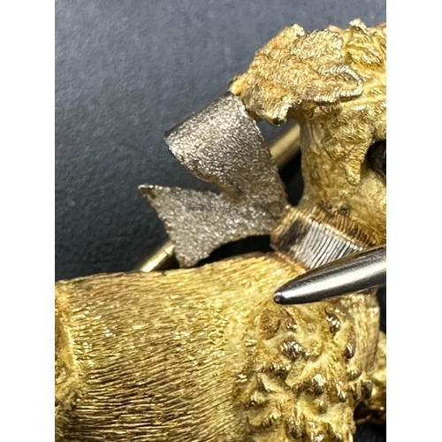 617 - An 18ct gold brooch of a small terrier with pearl capped stick in its mouth (Total weight 5.8g)