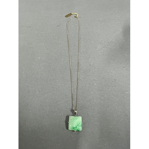 637 - A square jade pendant on a 9ct gold necklace.