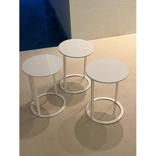 64 - Three white circular side tables