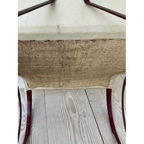 67 - A late Victorian rocking chair, upholstered later (H92cm W102cm D53cm)