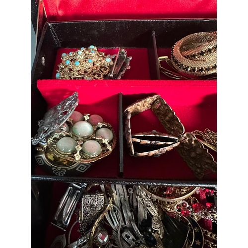 680H - A jewellery box with a variety of costume jewellery.