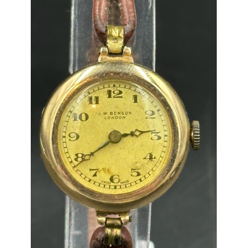 681 - A J W Benson of London ladies wristwatch in 9ct gold on leather bracelet.