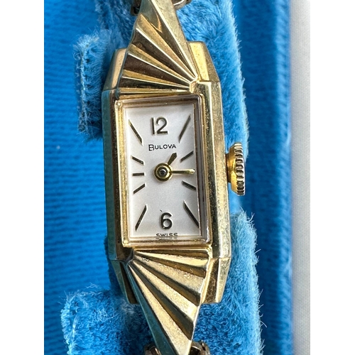 697 - A 14k yellow gold Bulova ladies wristwatch on gold plated bracelet with original box etc