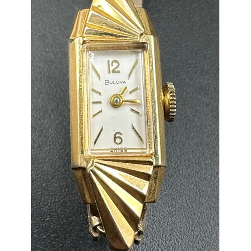 697 - A 14k yellow gold Bulova ladies wristwatch on gold plated bracelet with original box etc