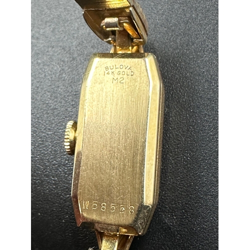 697 - A 14k yellow gold Bulova ladies wristwatch on gold plated bracelet with original box etc