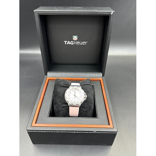 704 - A Ladies Tag Heuer Formula 1 watch with diamond bezel, box and papers on pink leather strap with pin... 