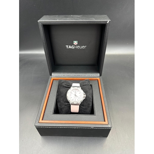 704 - A Ladies Tag Heuer Formula 1 watch with diamond bezel, box and papers on pink leather strap with pin... 