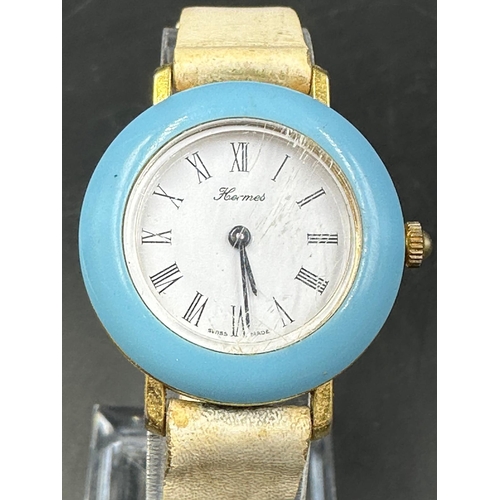 706 - A vintage Hermes, blue bezel watch on stainless steel with white leather strap.