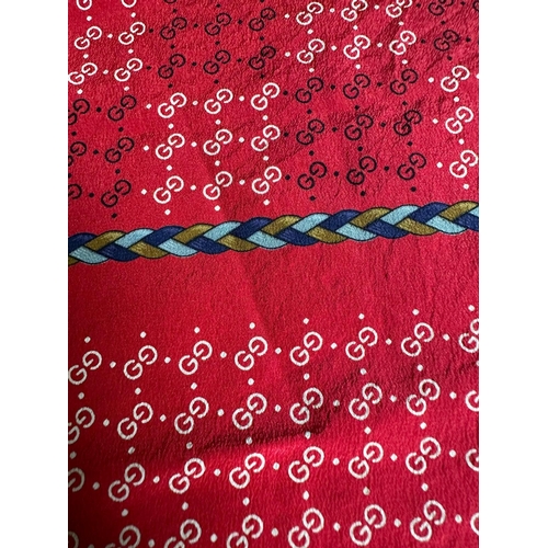 809 - A Vintage Gucci 100% silk scarf on red with logo.