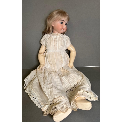 820 - An antique German doll with carved wooden body