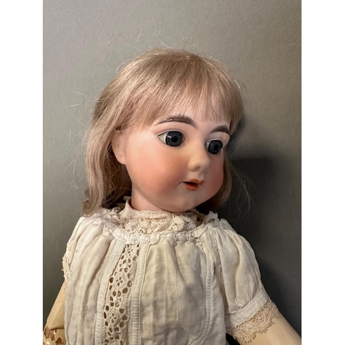 820 - An antique German doll with carved wooden body