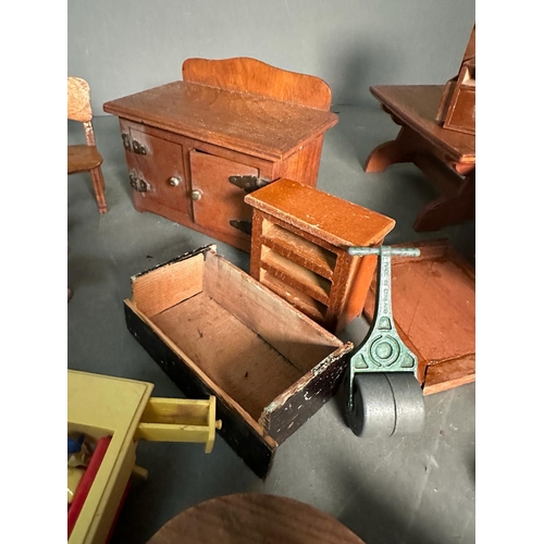 821 - A selection of vintage dolls house furniture to include chairs, sideboard and wardrobe