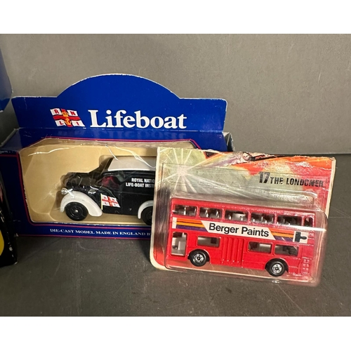 822 - Four boxed toy cars, Corgi lifeboats, a Corgi London bus and black cab and a Matchbox bus