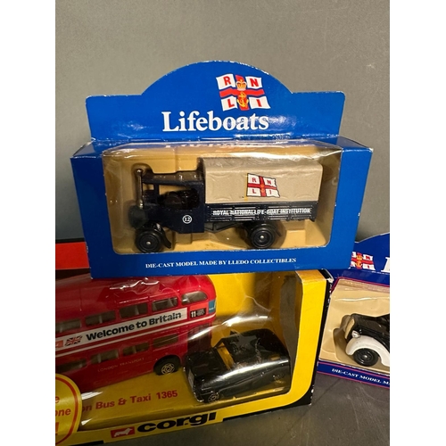 822 - Four boxed toy cars, Corgi lifeboats, a Corgi London bus and black cab and a Matchbox bus