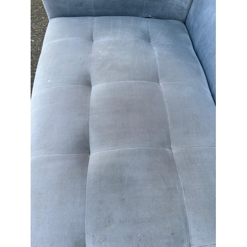 9 - A contemporary four seater sofa upholstered in grey on brass ball feet 230cm x 86cm