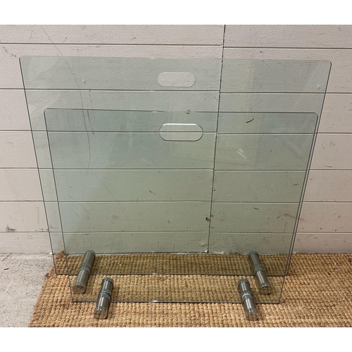 95 - Two contemporary glass and chrome fire screens (61cm x 65cm and 80cm x 70cm)