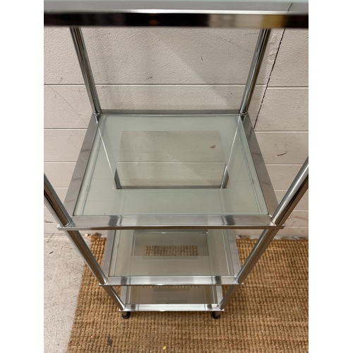 99 - A chrome and frosted glass four shelve unit (H97cm W37cm D29cm)