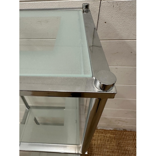 99 - A chrome and frosted glass four shelve unit (H97cm W37cm D29cm)