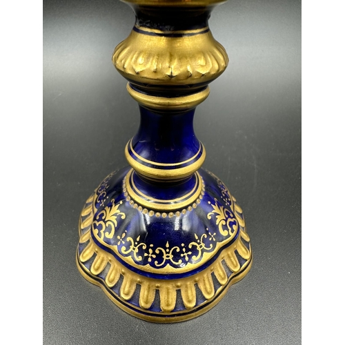 434A - An early 20th Century Coalport, three handled goblet with blue grounds under a acid etch gilt boarde... 