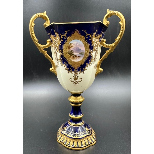 434A - An early 20th Century Coalport, three handled goblet with blue grounds under a acid etch gilt boarde... 