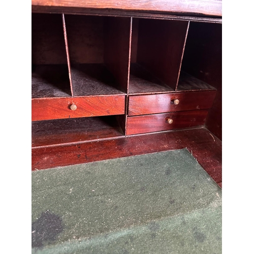 63 - A Georgian mahogany secretaire bookcase, glazed doors opening to shelves, the base fitted with strun... 