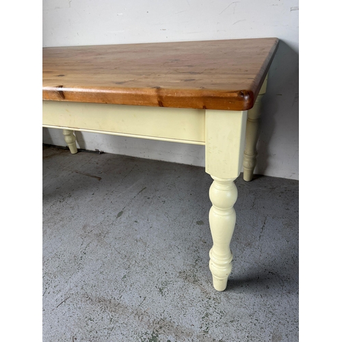 114 - A pine kitchen table with painted legs (H79cm W152cm D90cm)