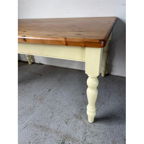 114 - A pine kitchen table with painted legs (H79cm W152cm D90cm)