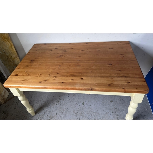 114 - A pine kitchen table with painted legs (H79cm W152cm D90cm)