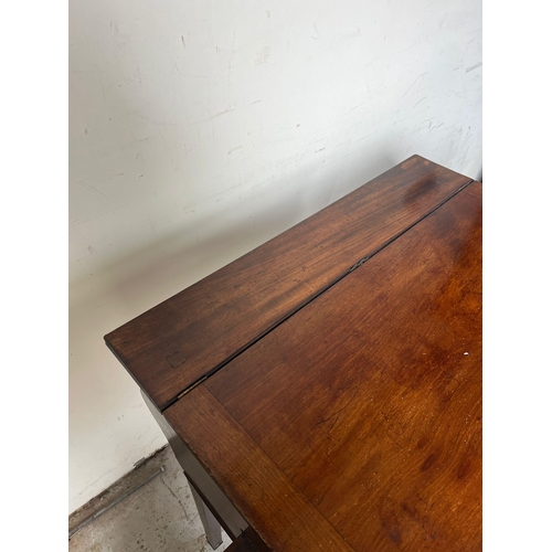 119 - A mahogany desk on tapering legs (H84cm W84cm D62cm)