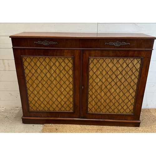 135 - A Regency style side cabinet silk lined, brass lattice doors opening to shelves (H90cm W120cm D29cm)