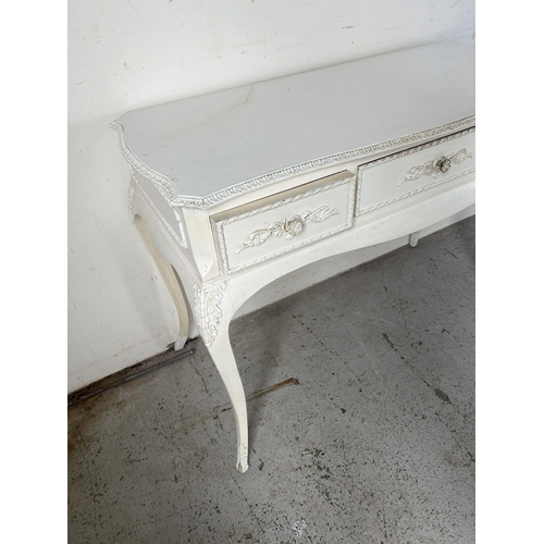 137 - A white Rococo style desk or dressing table (H77cm W104cm D59cm)