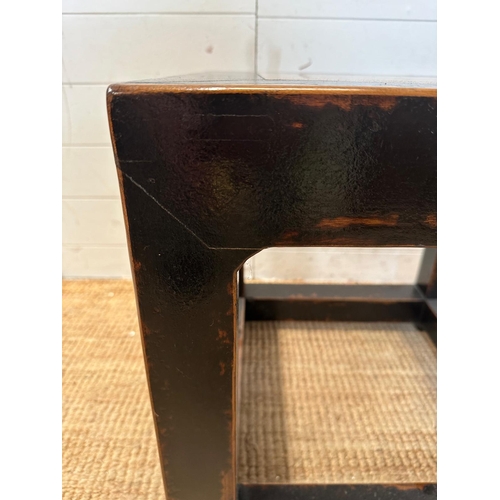 139 - A black hardwood geometric side table with polished stone insert to top (H49cm SQ49cm)