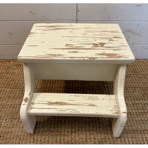 149 - A white painted step footstool with a hinged lid opening to storage