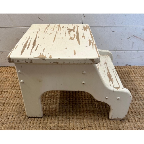 149 - A white painted step footstool with a hinged lid opening to storage