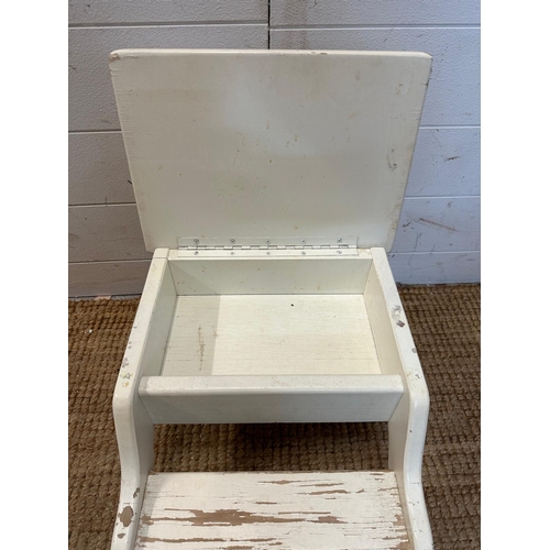 149 - A white painted step footstool with a hinged lid opening to storage