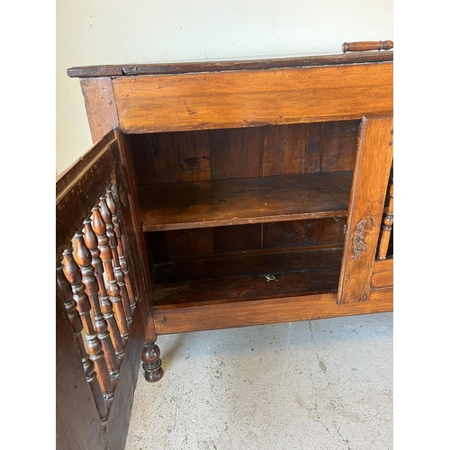 159 - An 18th century fruitwood/walnut Welsh food cupboard with spindle front on turned legs and a hinged ... 