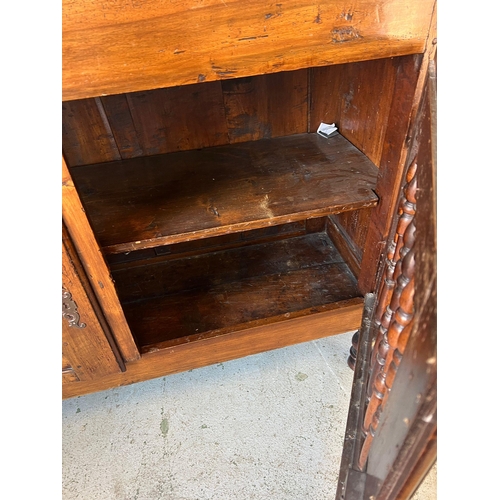 159 - An 18th century fruitwood/walnut Welsh food cupboard with spindle front on turned legs and a hinged ... 