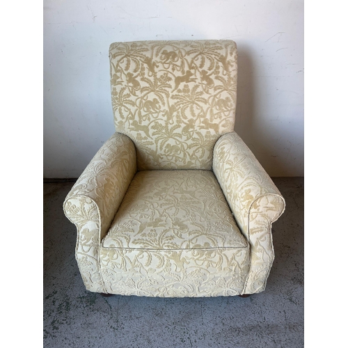 165 - A cream lounge chair on bun feet