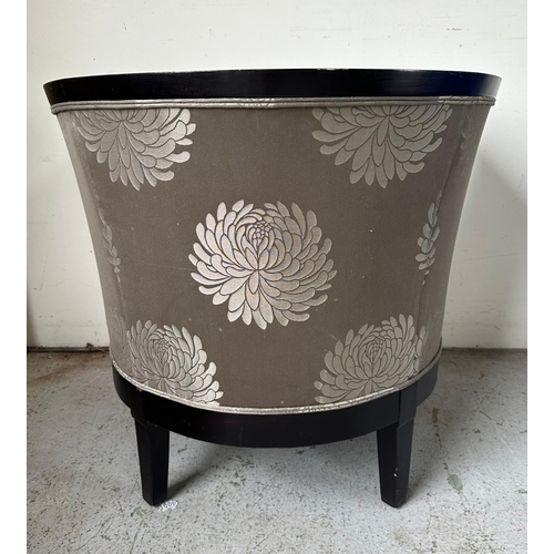 167 - An Art Deco style tub chair, black framed and upholstered in a silver and grey floral upholstery