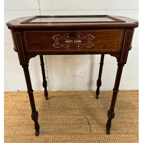 17 - A Victorian bijouterie table with string and scrolling floral inlay on turned legs and casters with ... 