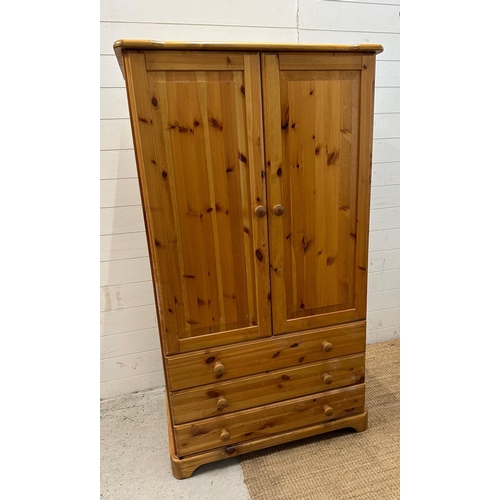 171 - A pine two door wardrobe with three drawers under (H157cm W84cm D52cm)