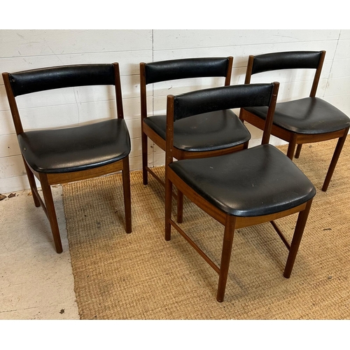 18 - A set of four black leather upholstered McIntosh dinning chairs