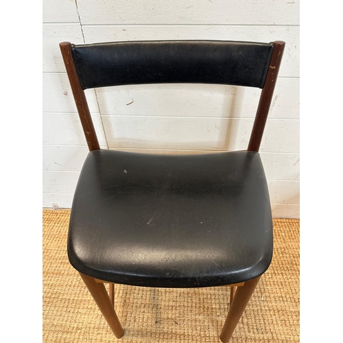 18 - A set of four black leather upholstered McIntosh dinning chairs