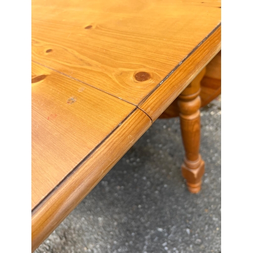 180 - A pine drop sided kitchen table with extension (H77cm W108cm D68cm Open W164cm)