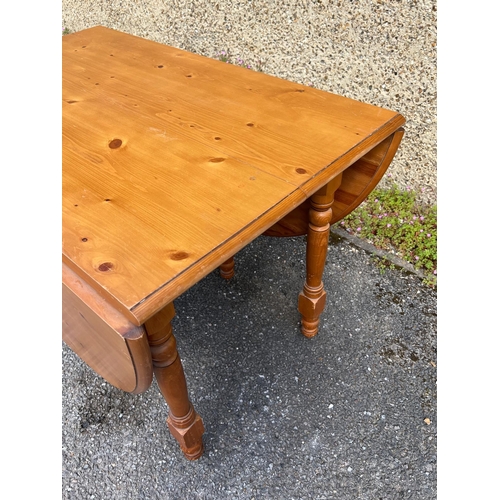 180 - A pine drop sided kitchen table with extension (H77cm W108cm D68cm Open W164cm)