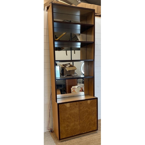 181 - A contemporary mirror backed bookcase with four shelves and a two door cupboard under (H244 W85cm D4... 