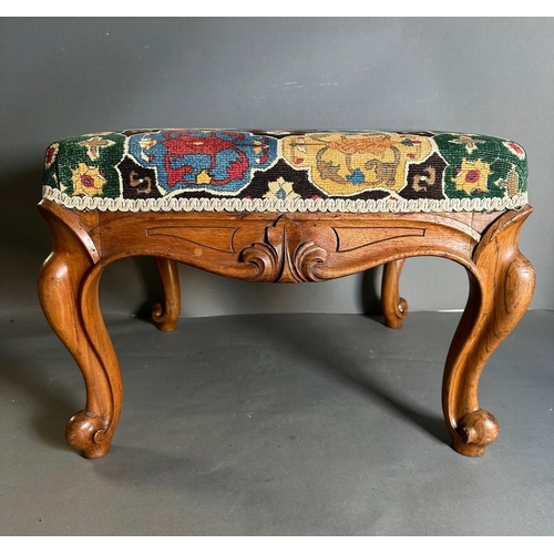 2 - A vintage Louis style footstool in a shield , multicoloured upholstery on a carved frame with cabrio... 