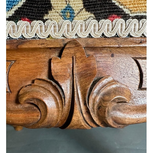 2 - A vintage Louis style footstool in a shield , multicoloured upholstery on a carved frame with cabrio... 