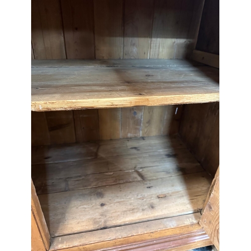 20 - A vintage pine Welsh dresser, three shelf plate rack and two cupboard under